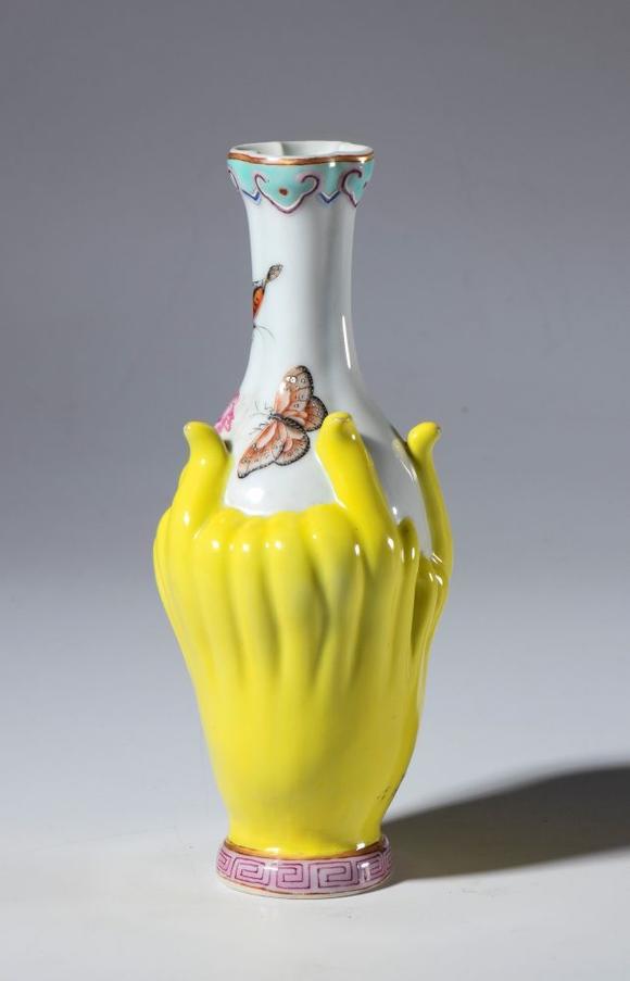 Bertolami Fine ArtPorcelain vase painted with flowers and butterflies. The body of the vase is meant to resemble the fruit of the 