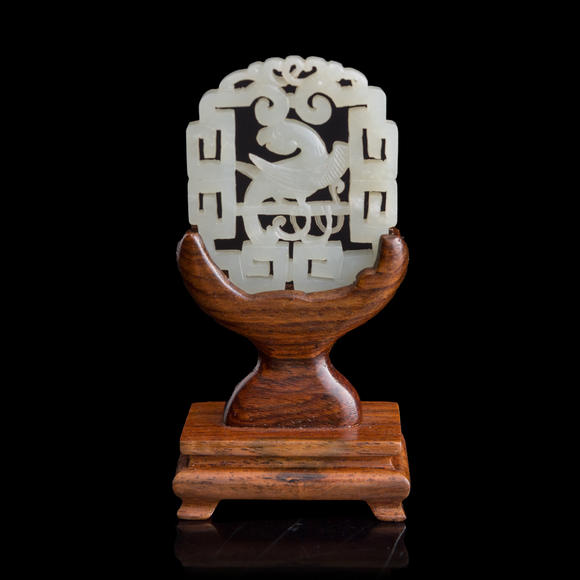 Oakridge Auction Gallery十八世紀(jì) 白玉鏤雕鸚鵡佩（附木座）  A Chinese reticulated white jade 'parrot' plaque