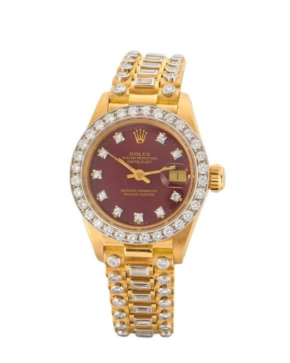 RoseberysRolex. An 18ct gold and diamond set bracelet watch with burgundy dia