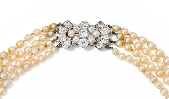 DreweattsAN EARLY 20TH CENTURY FOUR ROW NATURAL PEARL AND DIAMOND NECKLACE