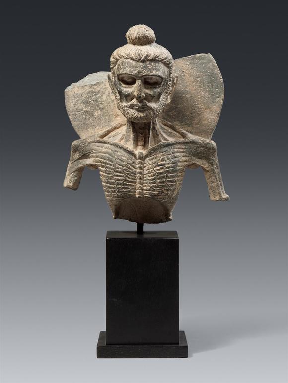 Kunsthaus Lempertz KGA Gandharan grey schist bust of Emaciated Buddha. Pakistan, Gandhara. Kushan period, 2nd/3rd century