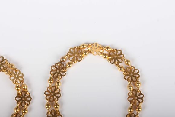 TooveysA gold necklace in a pierced circular and twin bead link design, unm