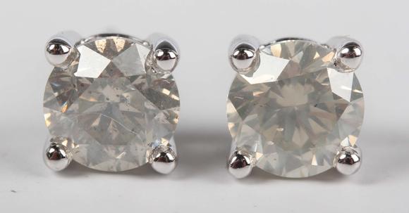 TooveysA pair of platinum and diamond single stone earstuds, each claw set