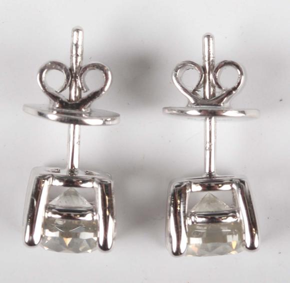 TooveysA pair of platinum and diamond single stone earstuds, each claw set
