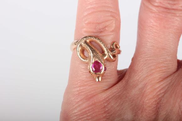 TooveysA gold, ruby and synthetic ruby ring, designed as a coiled snake, de