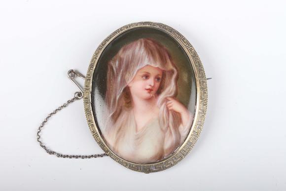TooveysA Continental oval porcelain brooch, painted with a portrait of a ma