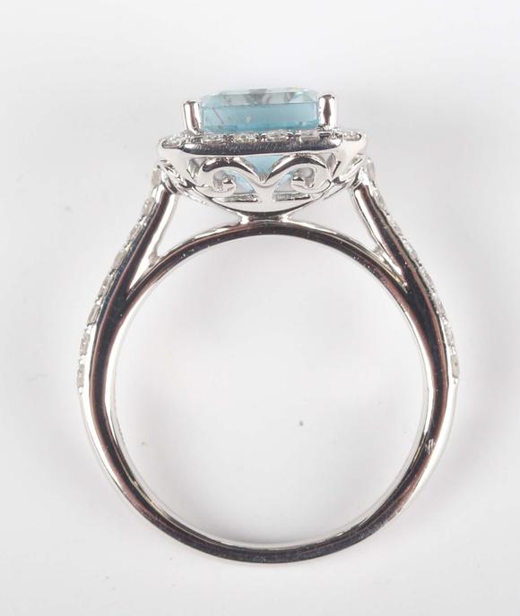 TooveysA platinum, aquamarine and diamond cluster ring, claw set with the c