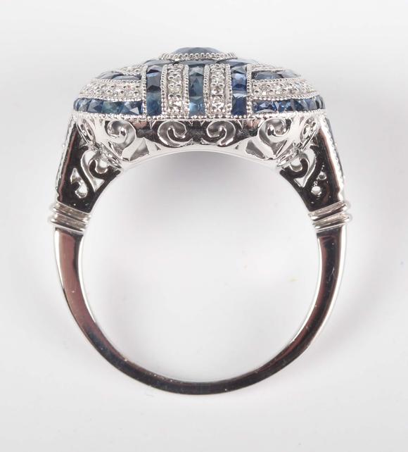 TooveysA platinum, sapphire and diamond panel ring in an Art Deco inspired
