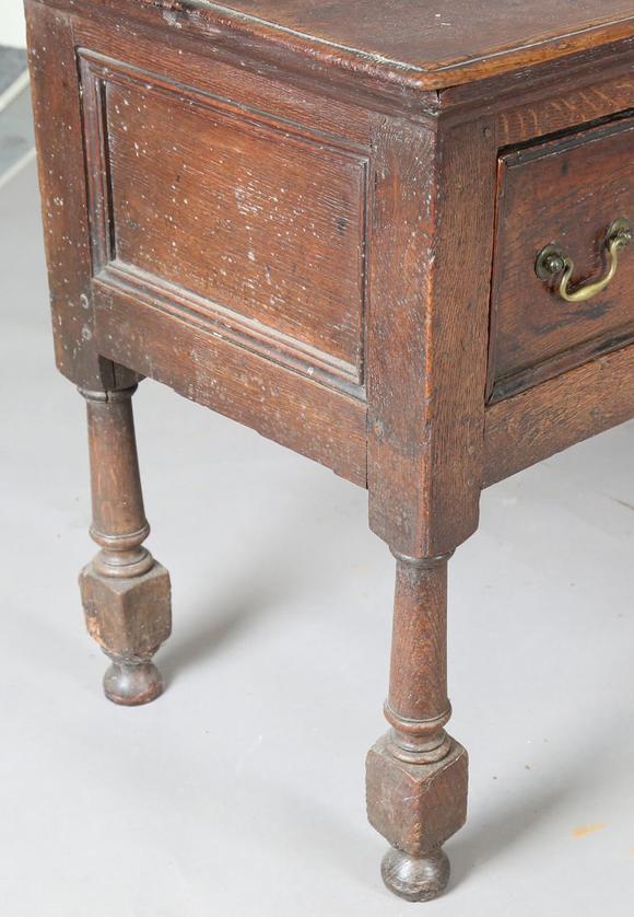 TooveysAn 18th century provincial oak dresser base, fitted with three drawe