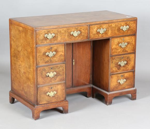 TooveysA 20th century George I style walnut kneehole desk with overall feat