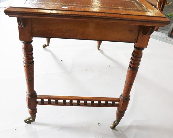 TooveysA late Victorian oak writing table, the top inset with gilt-tooled b