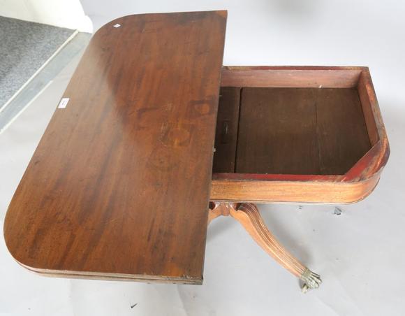 TooveysA Regency mahogany fold-over tea table, raised on a spiral reeded st