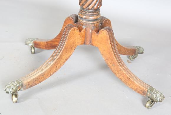 TooveysA Regency mahogany fold-over tea table, raised on a spiral reeded st