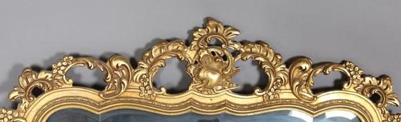 TooveysA late 20th century gilt composite wall mirror of shaped form, the f