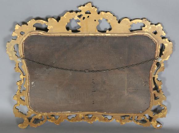 TooveysA late 20th century gilt composite wall mirror of shaped form, the f