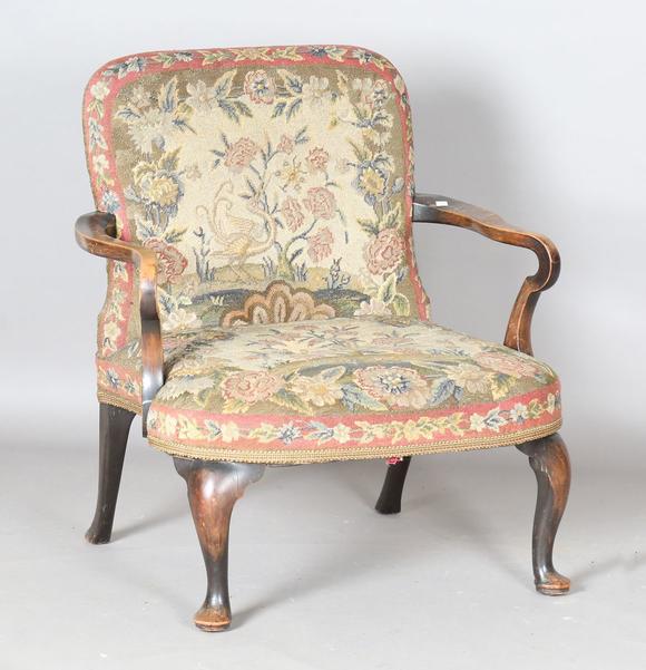 TooveysAn early 20th century walnut framed low armchair with a woolwork sea