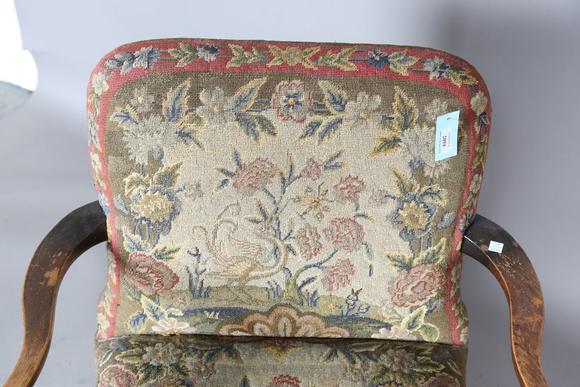 TooveysAn early 20th century walnut framed low armchair with a woolwork sea