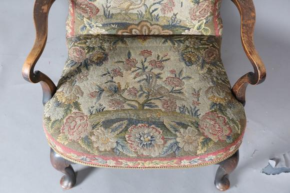 TooveysAn early 20th century walnut framed low armchair with a woolwork sea
