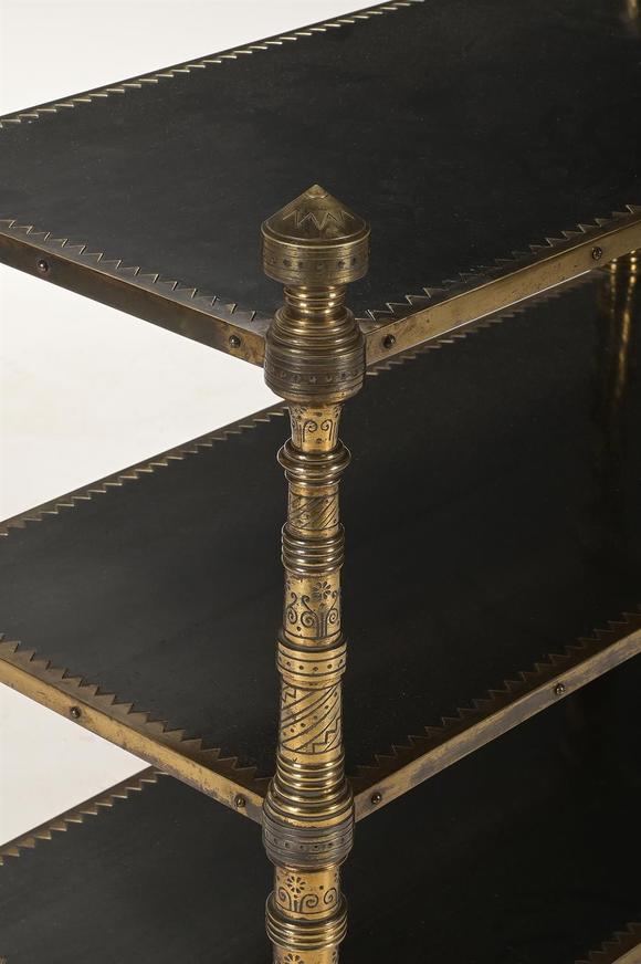 DreweattsAN UNUSUAL AESTHETIC MOVEMENT EBONISED AND ENGRAVED GILT BRASS THREE TIER ETAGERE
