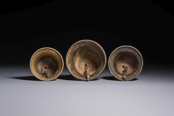 Rob Michiels AuctionsThree Tibetan bronze ritual bells and a bronze Buddha, 19th C.