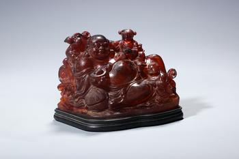 A Red Amber Group of Budai with Five Boys, Wood Stand, China, 14th–17th centuries