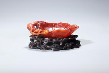 A Red Stone Lotus Leaf Brush Washer with Foliage Carving, Wood Stand, China, 14th–17th centuries
