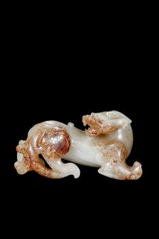 A White Jade Mythical Beast Carving with Russet Inclusions, Han, Circa 2nd C BC–2nd C AD Pr.