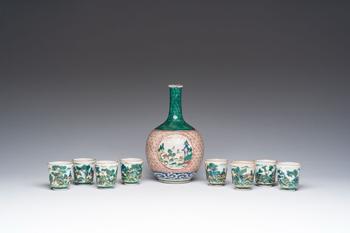 A Japanese Kutani 'tokuri' or sake bottle and eight cups with landscape design, Meiji, 19th C.