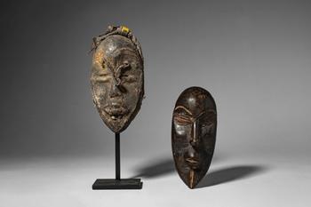 Ca. late 19th - early 20th century AD. >
A group comprising two carved wooden miniature masks of