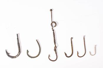 Ca. 19th century AD. 
A collection of six forged metal fish hooks of varying sizes and forms, wit