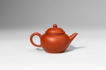 Qing Dynasty, Ca. AD 1644 - 1912. >A Yixing teapot of classic globular form, the rounded body ris