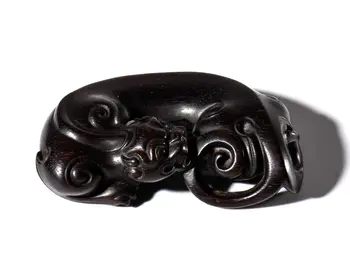 A dragon figurine carved from sandalwood. China, 20th century.
