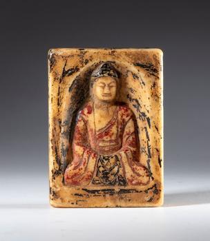 White marble relief with traces of polychromy depicting Buddha in meditation. China, 19th century.