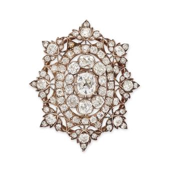 A late Victorian diamond pendant/brooch, of openwork form, set with old-cut diamonds of varying size, mounted in silver, backed with gold, to a radiat