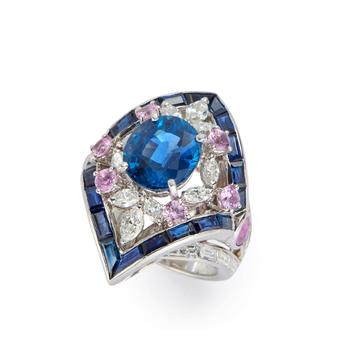 A sapphire, diamond and pink sapphire cluster ring, the lozenge shaped cluster with central single oval mixed-cut sapphire in four claw setting, withi