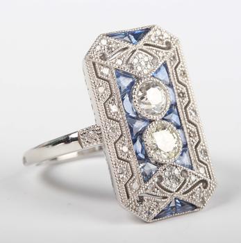 A platinum, sapphire and diamond panel ring in an Art Deco inspired
