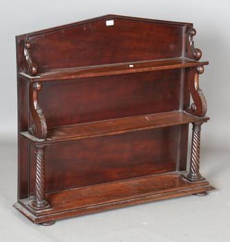 An early Victorian mahogany three-tier graduated bookshelf with scro
