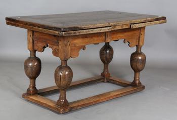 A 17th century oak draw-leaf refectory table, the rectangular top ra