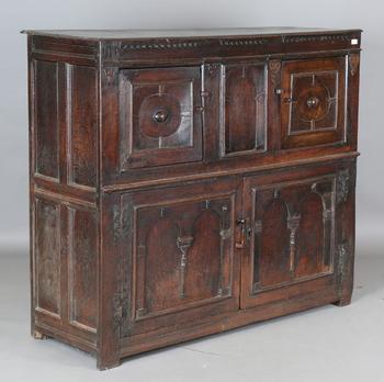 A 17th century oak side cupboard, fitted with four panelled doors, h