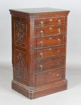 A late Victorian Aesthetic Movement stained oak chest of six drawers