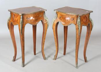 A pair of 20th century French mahogany bedside tables of shaped bomb