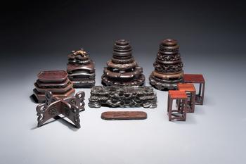 A collection of 25 Chinese wooden stands, 19/20th C.